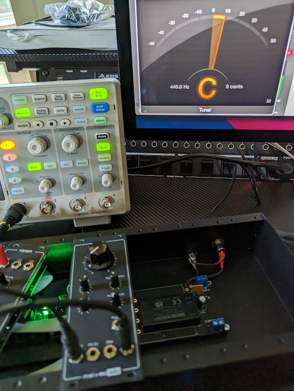 The VCO during tuning. A digital tuner is shown on a computer screen in the background of the image, as well as the right side of an oscilliscope. The digital tuner shows that the VCO is about 9 cents sharp.